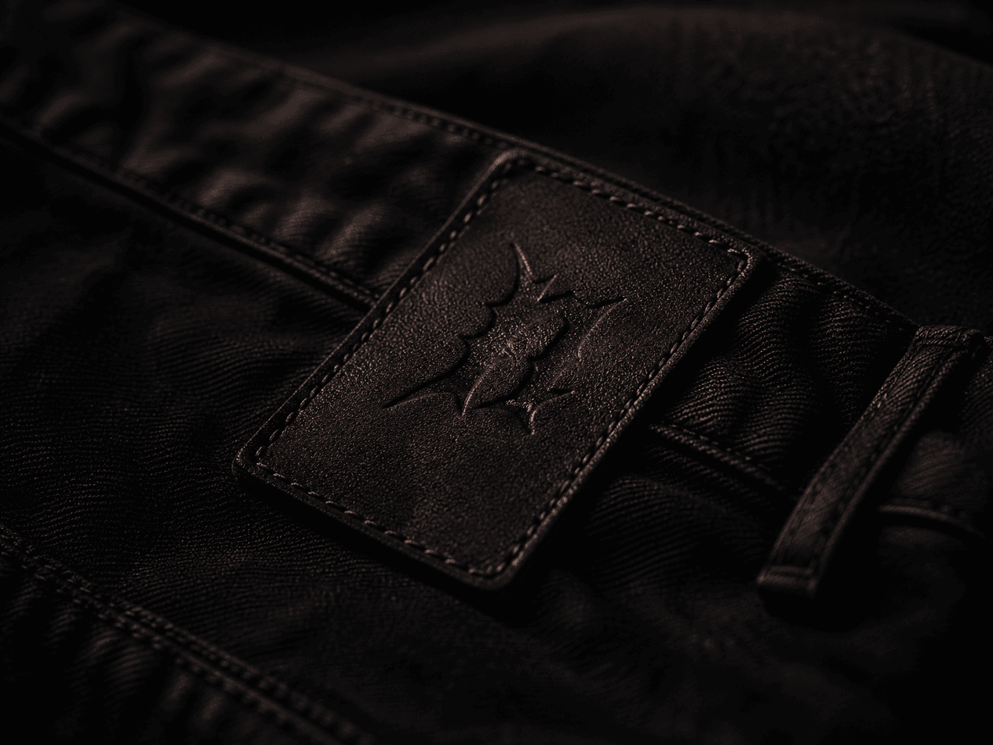Embossed leather patch on dark denim